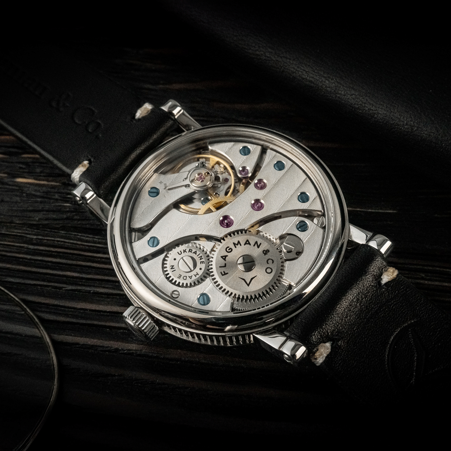 Rear view of Bohemia Black watch showing open caseback and manual winding movement