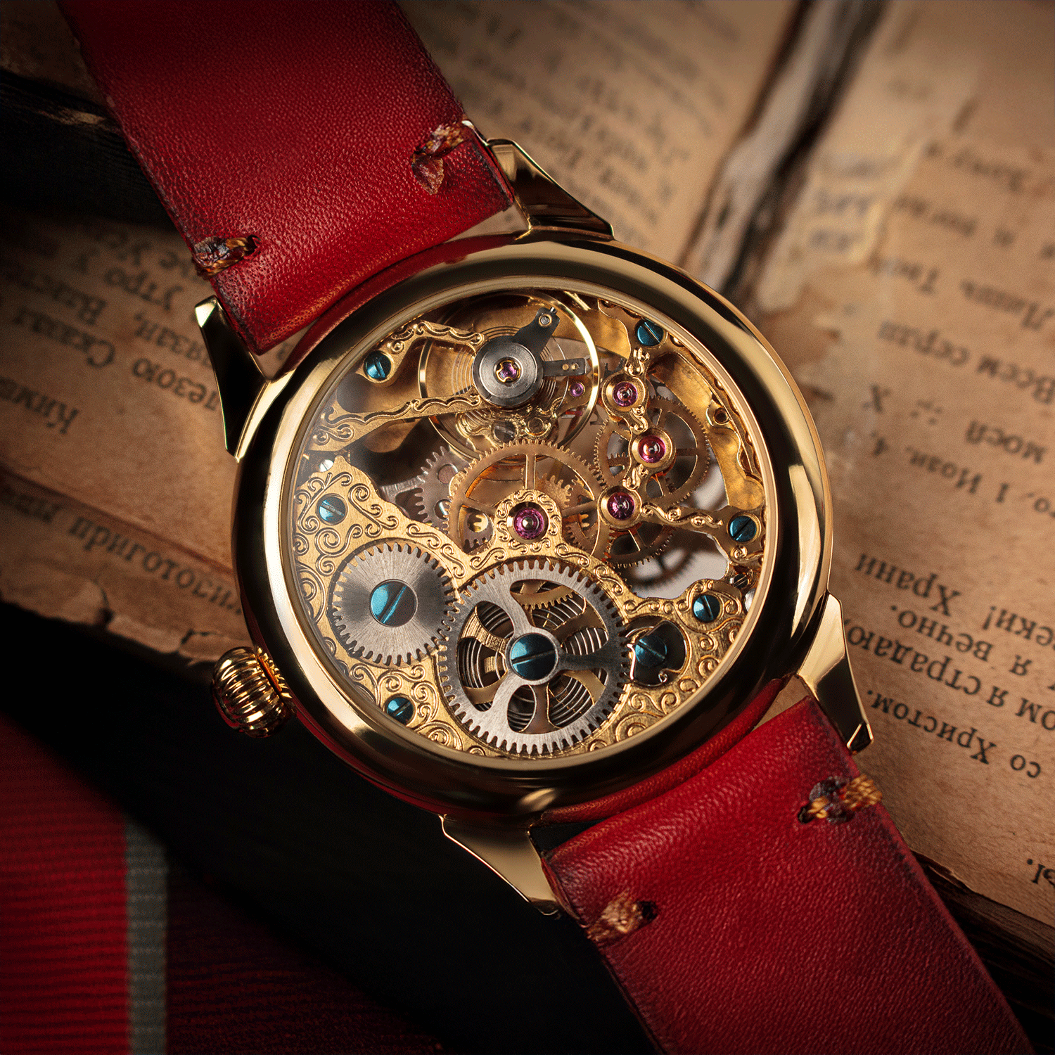 Skeleton watch with red leather strap on an old book
