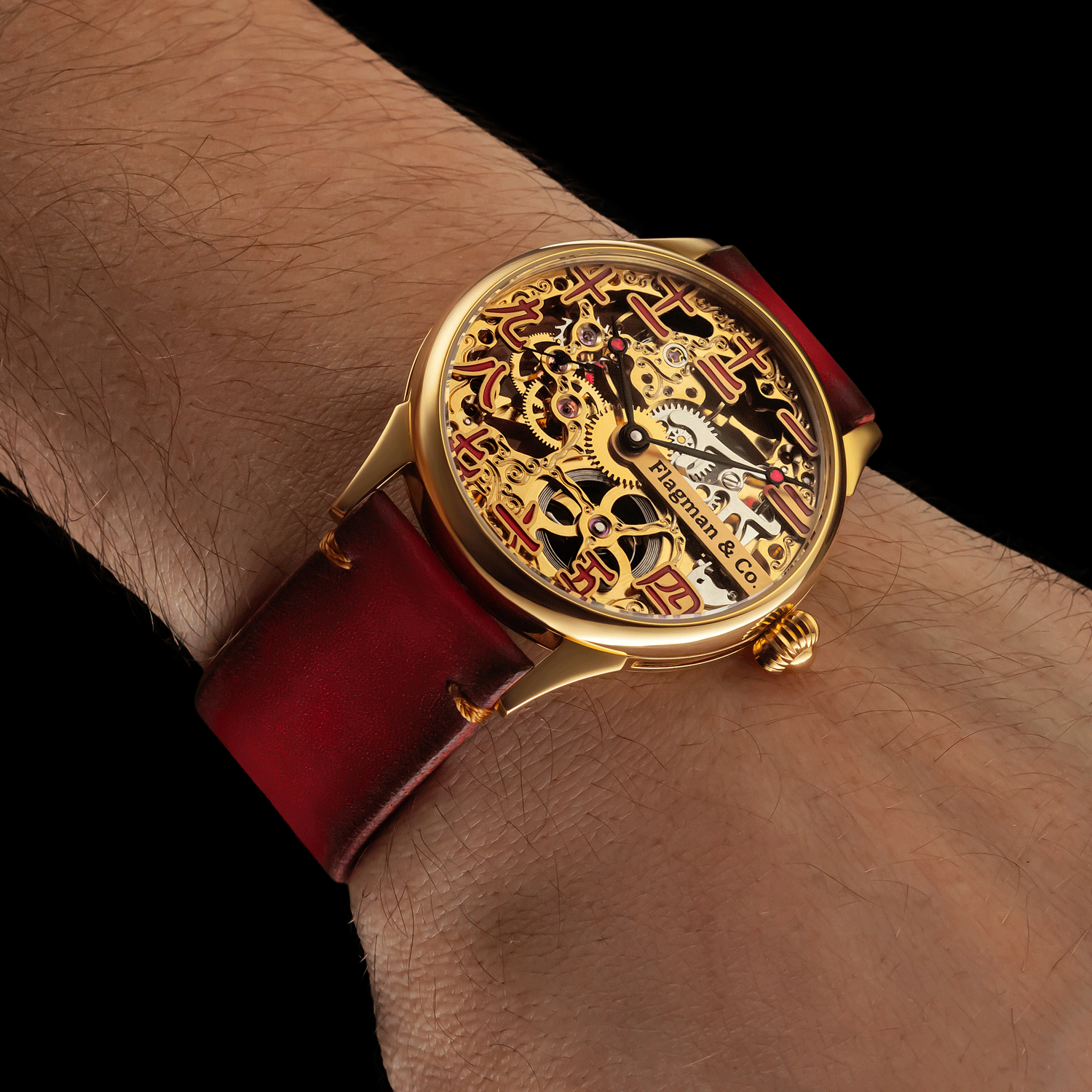 Skeleton wristwatch with green leather strap on a wrist against a black background