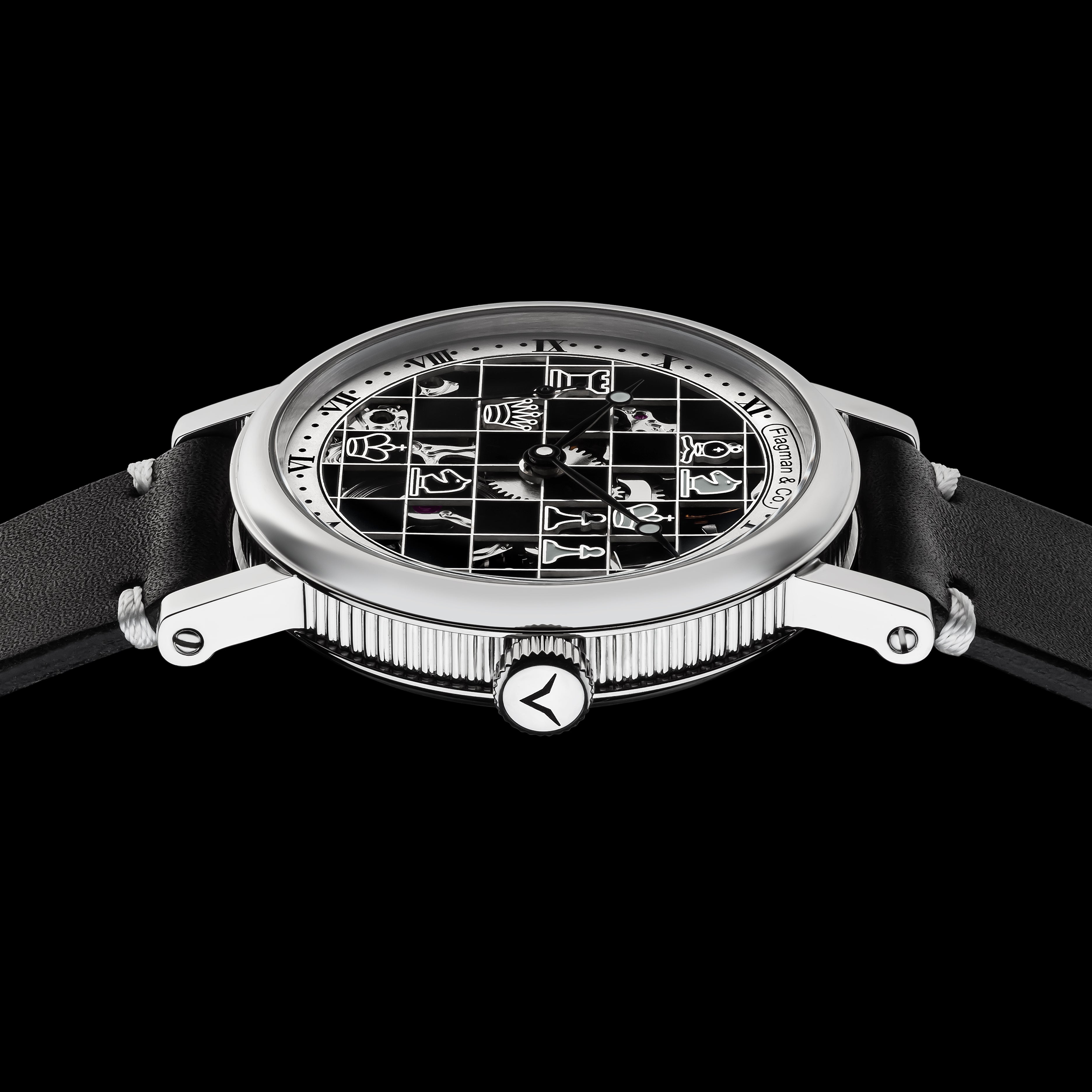 Watch with a black face and silver case on a black background