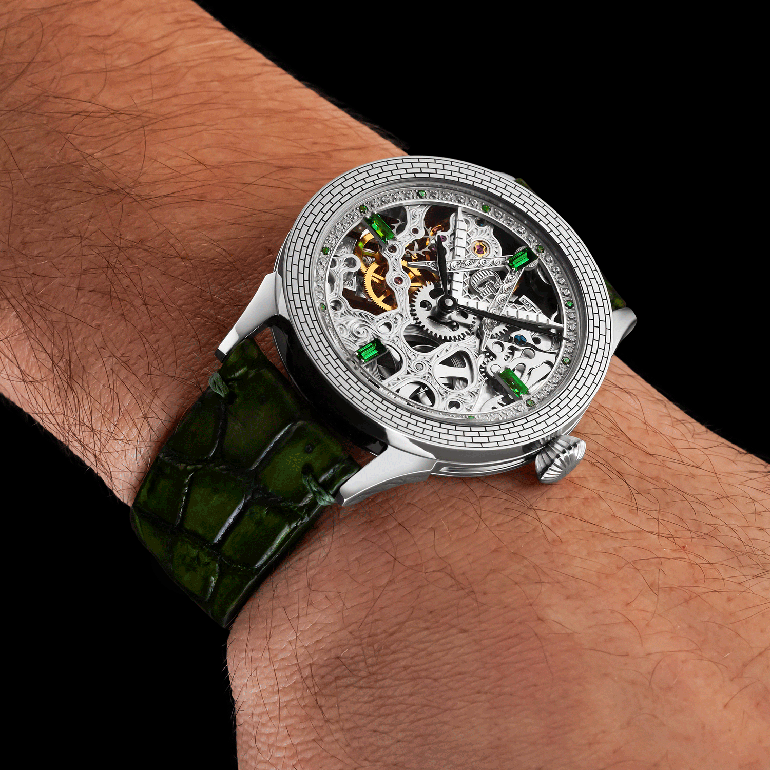 Luxury watch with green strap on a wrist against a black background