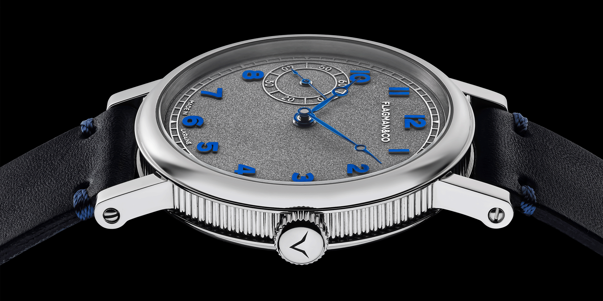 Handmade watch with a gray dial featuring blue hour markers on a black background