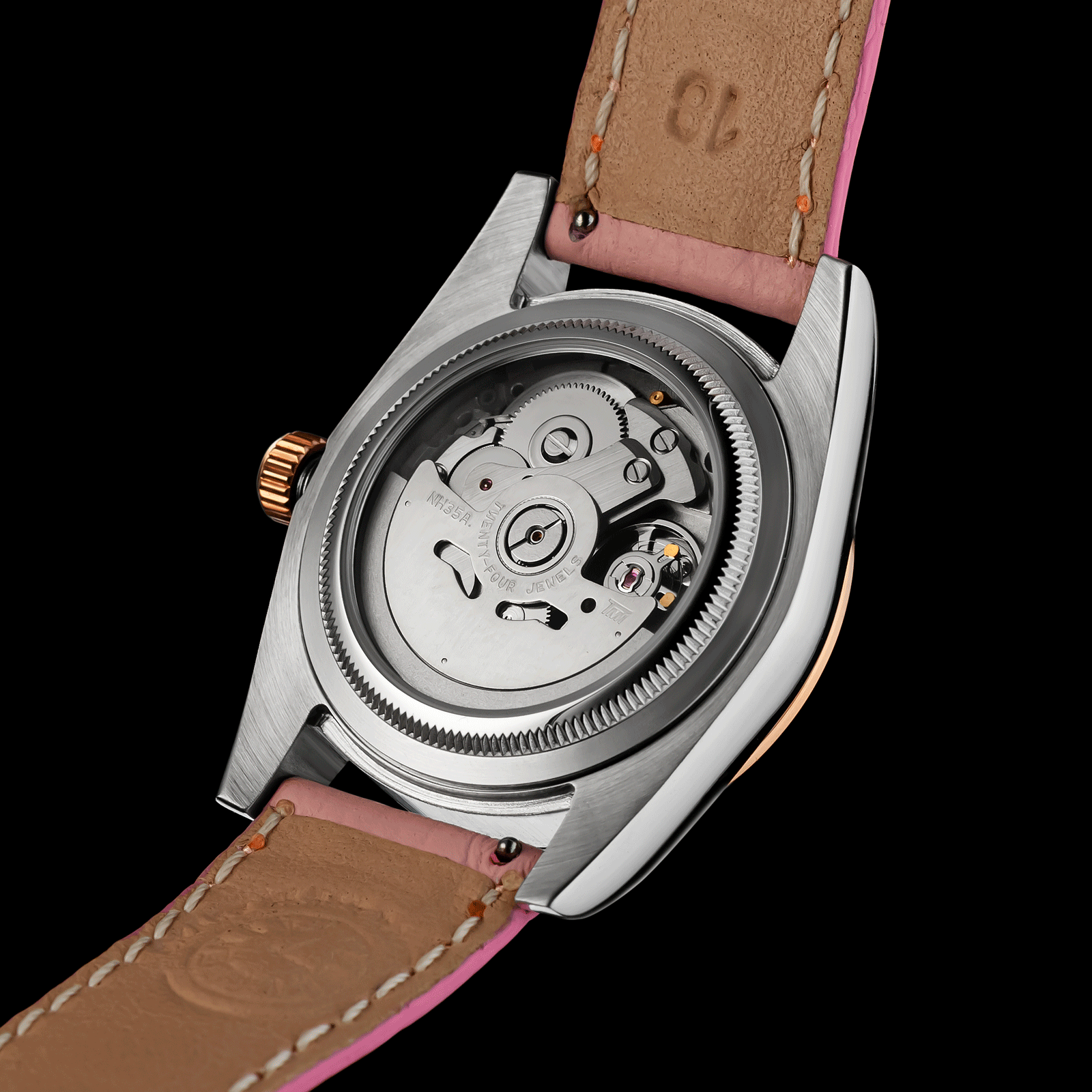 Womens Watch with pink leather strap and visible mechanical components on a black background