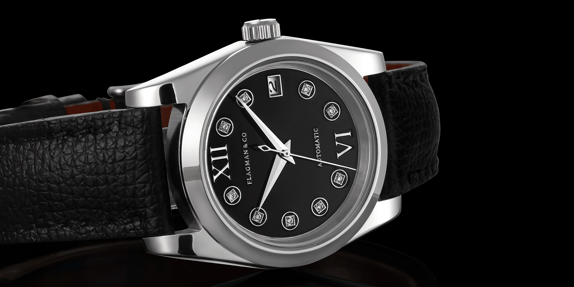 Luxury watch with black dial and leather strap on a black background