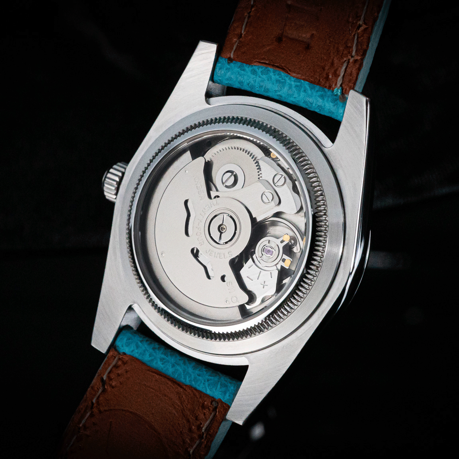 Watch with light-blue leather strap and blue interior on a black background