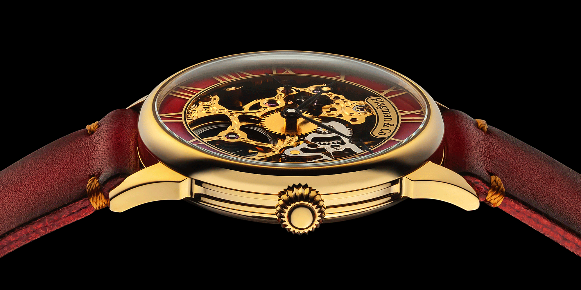 Skeleton watch with gold case, red leather strap, and intricate face design on a black background