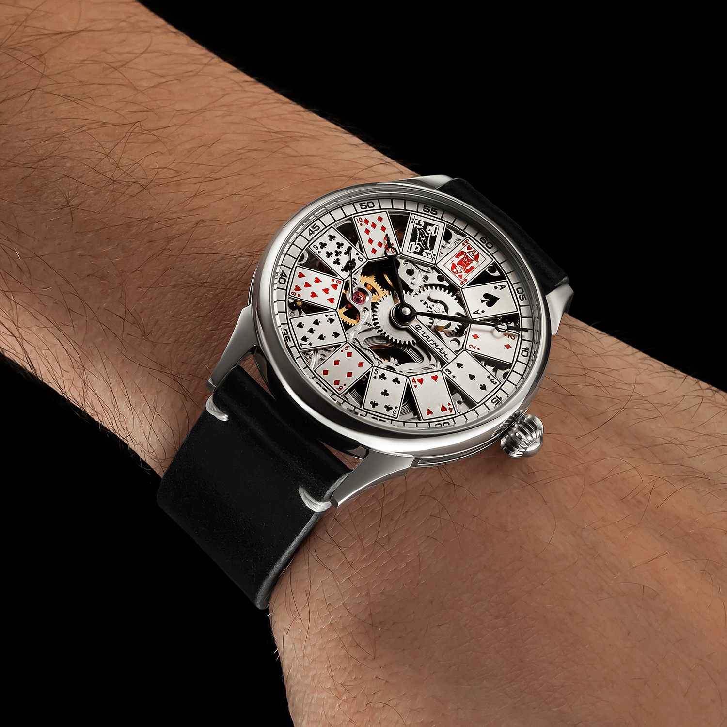Front view of handmade skeleton mechanical watch worn on wrist – poker-inspired design