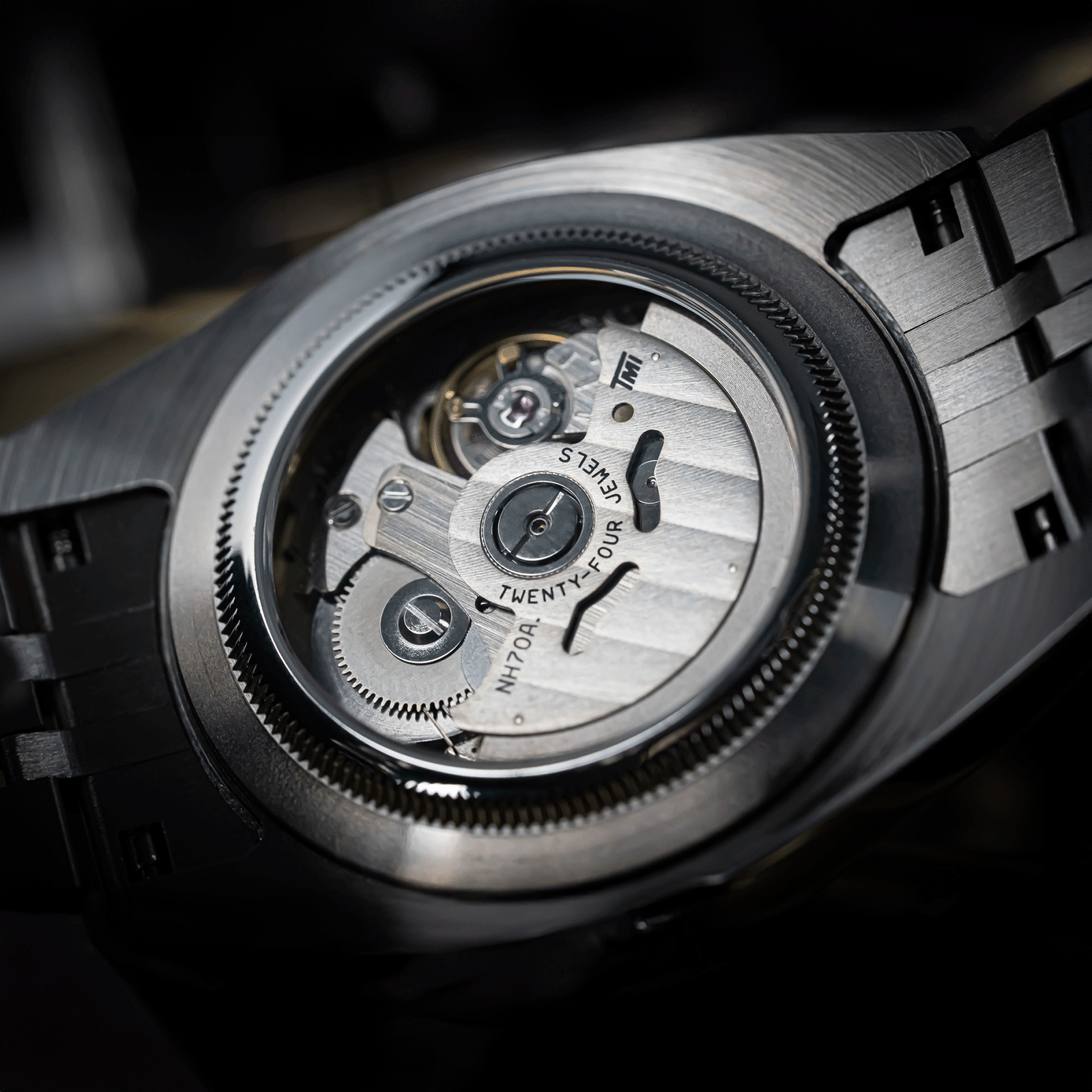 Close-up of a watch movement with visible brand name on a dark background