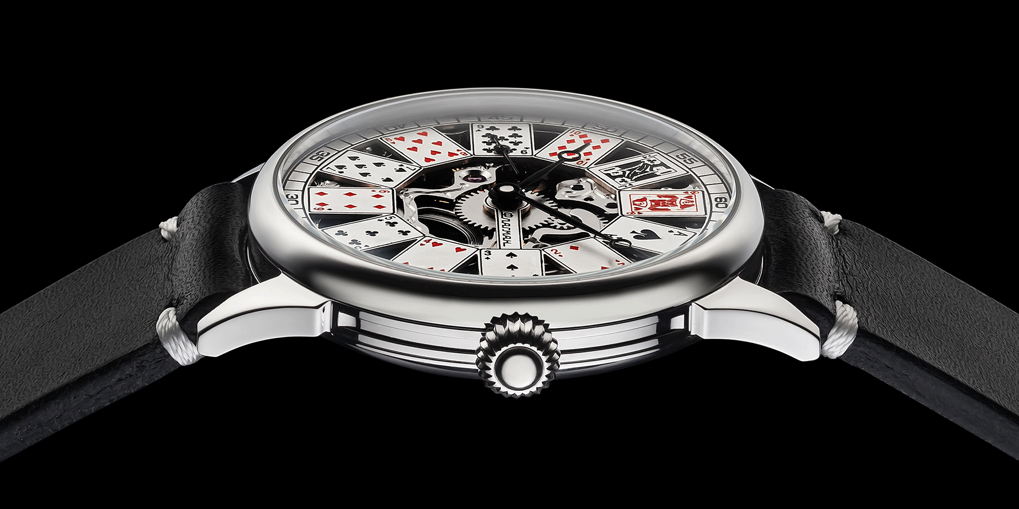 Close-up of poker-themed skeleton watch crown – worn on wrist, handcrafted detail visible