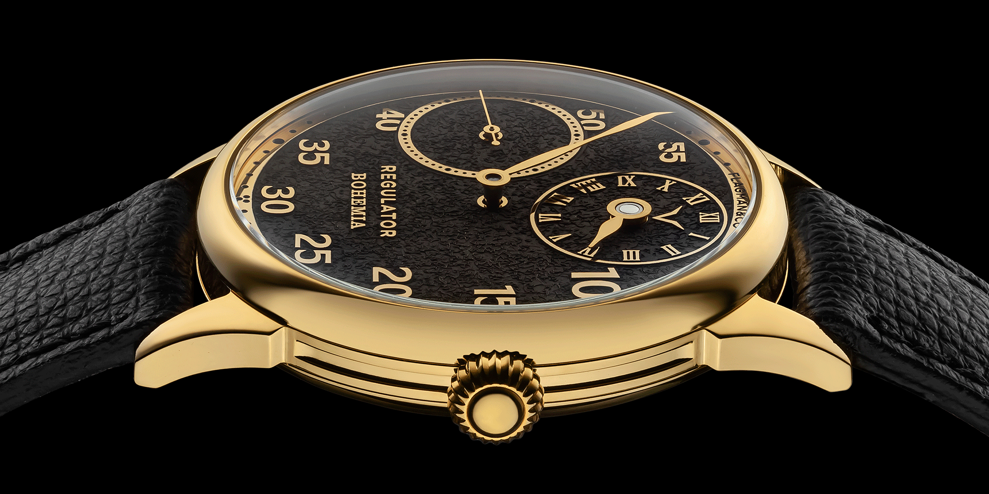 Handmade wristwatch with black face on a black background