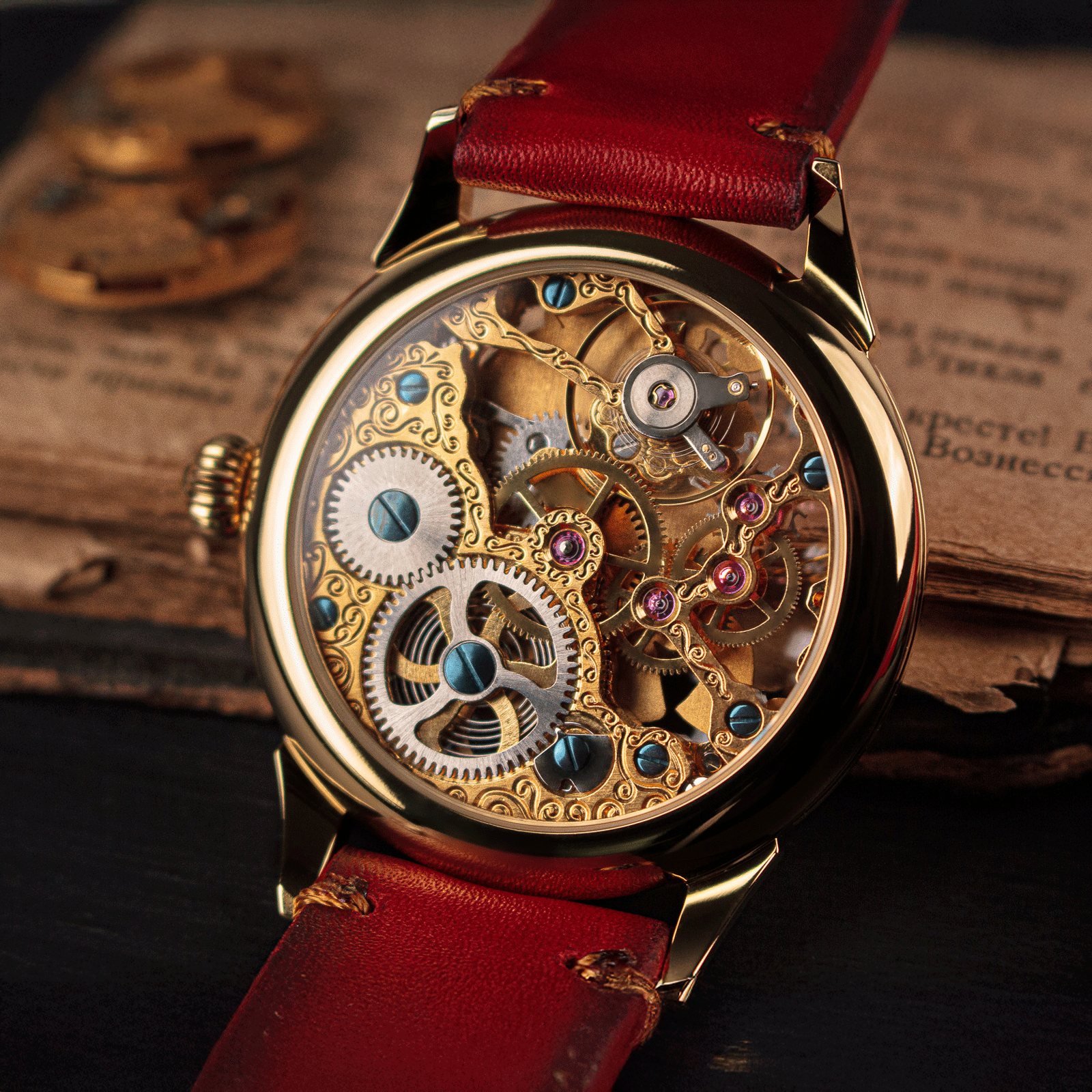 Skeleton Mechanical watch with red leather strap on an old book