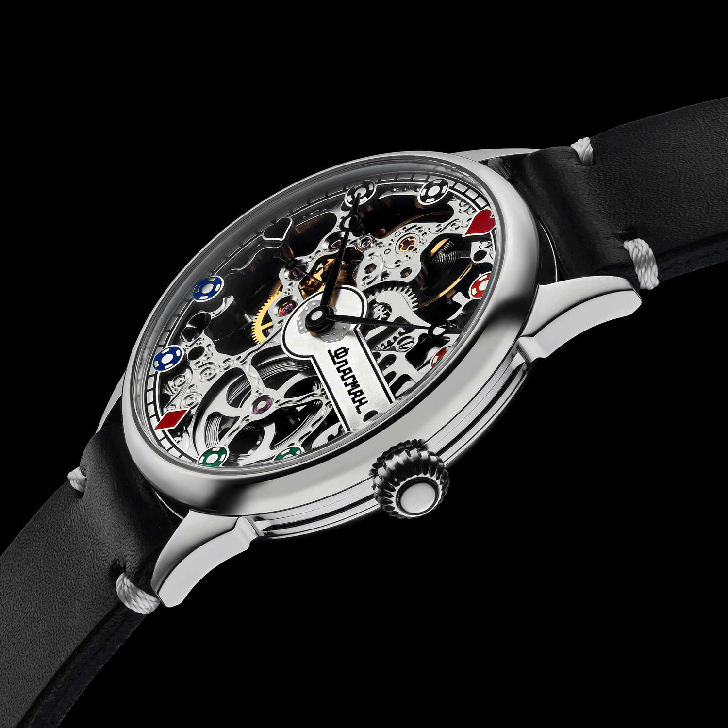 Close-up of poker-themed skeleton mechanical watch crown – worn on wrist, handcrafted detail visible