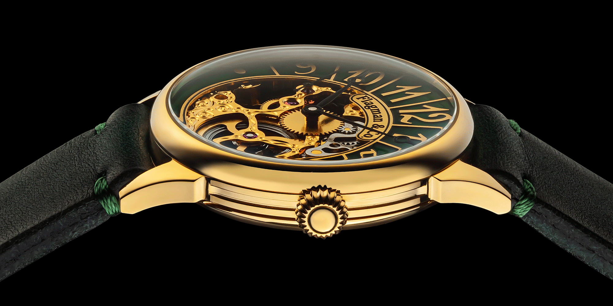 Skeleton gold watch with green strap on a black background