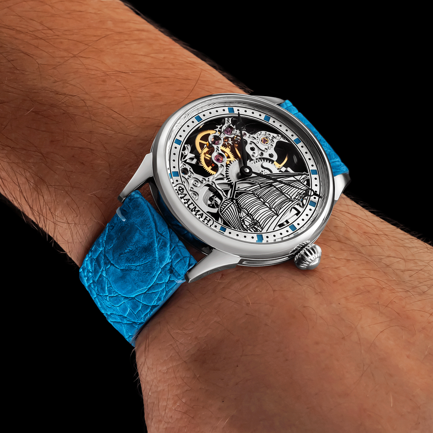 Wrist wearing a watch with a blue strap on a black background