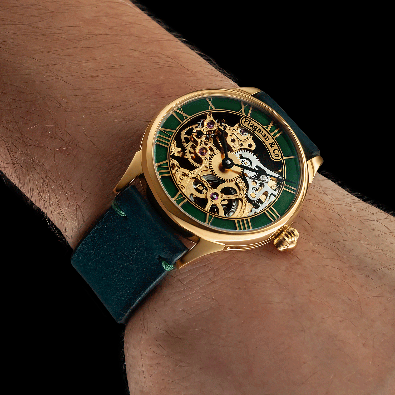 Skeleton watch with green strap and gold case on a wrist against a black background