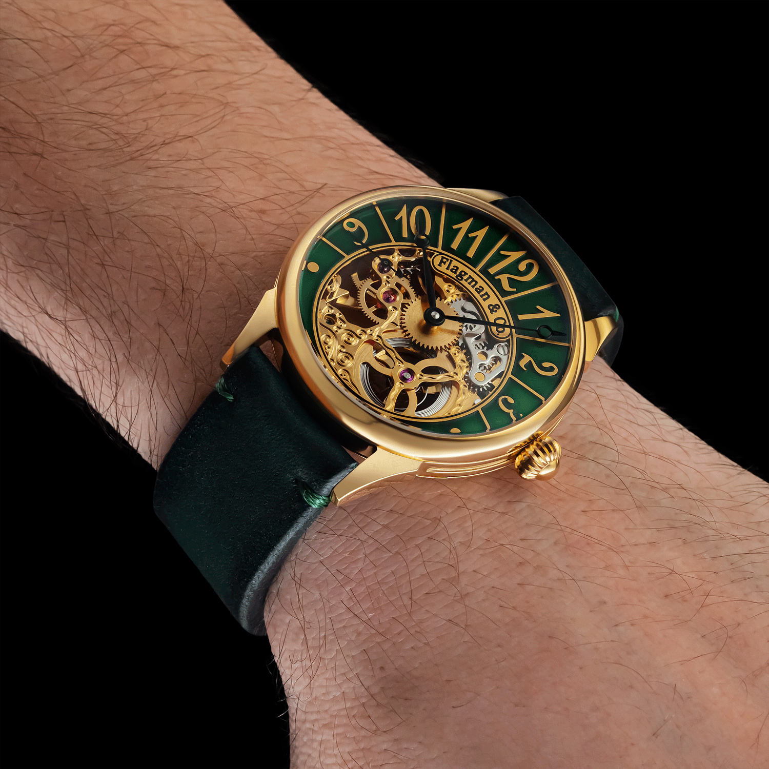 Luxury watch with green face and gold case on a wrist against a black background