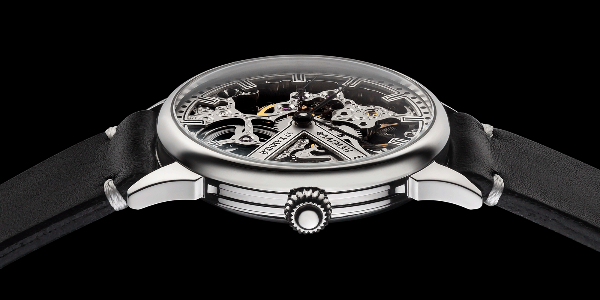 Handmade Watch with black strap and visible mechanical components on a black background