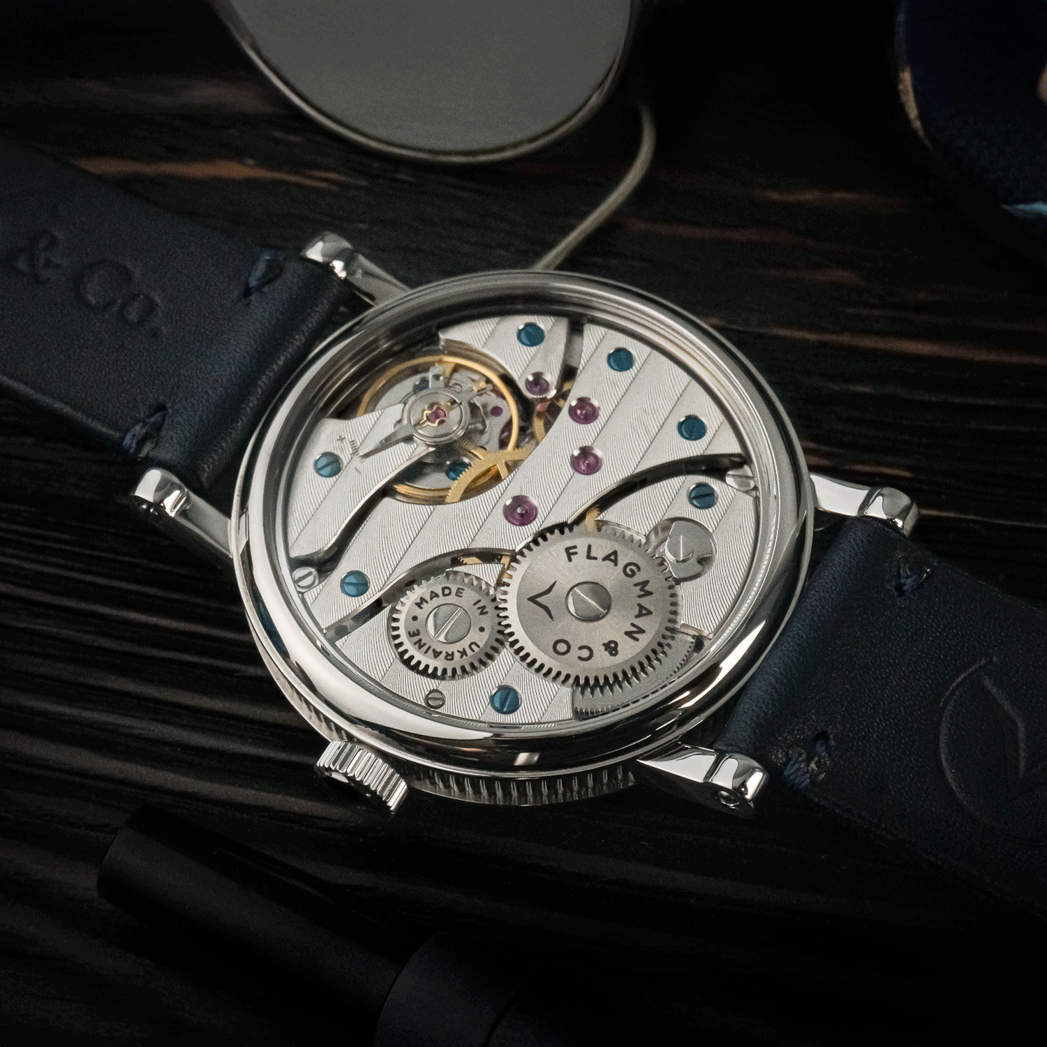 Rear view of Bohemia Blue watch showing open caseback and manual winding movement