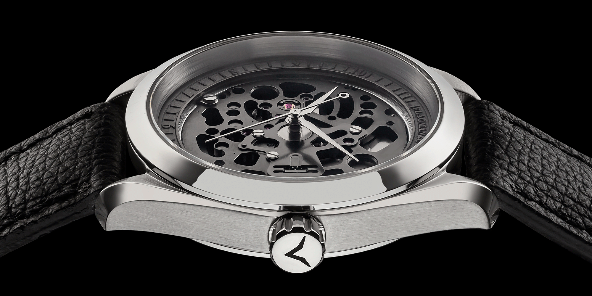 Steampunk watch with black leather strap on a black background