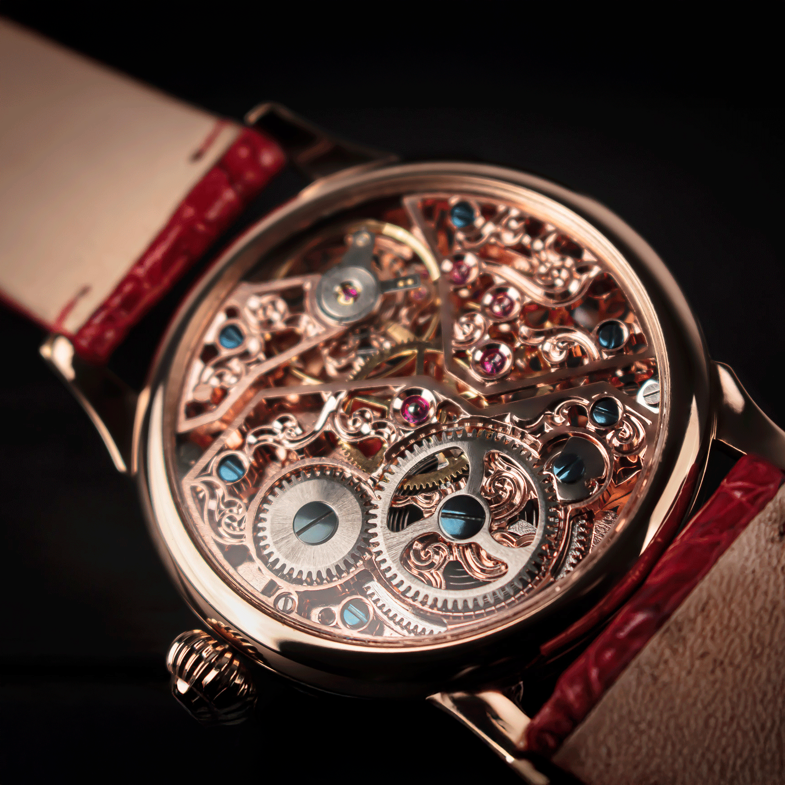 Close-up of a Skeleton mechanical watch with a red strap on a dark background