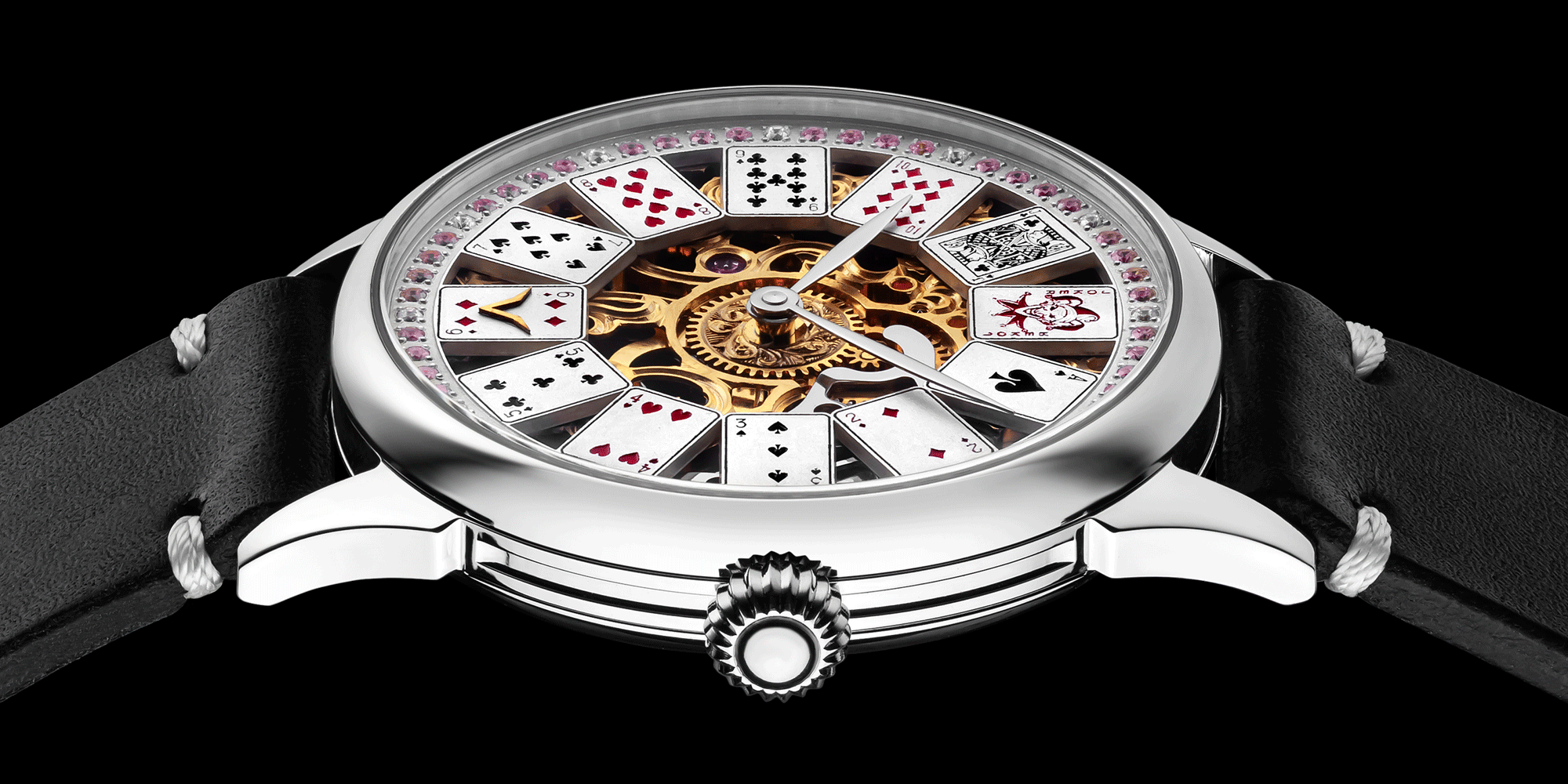 Close-up of poker-themed skeleton mechanical watch crown – worn on wrist.