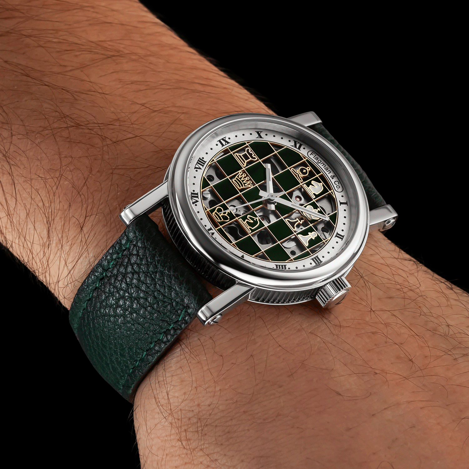 Handmade Watch with green strap on wrist against a black background
