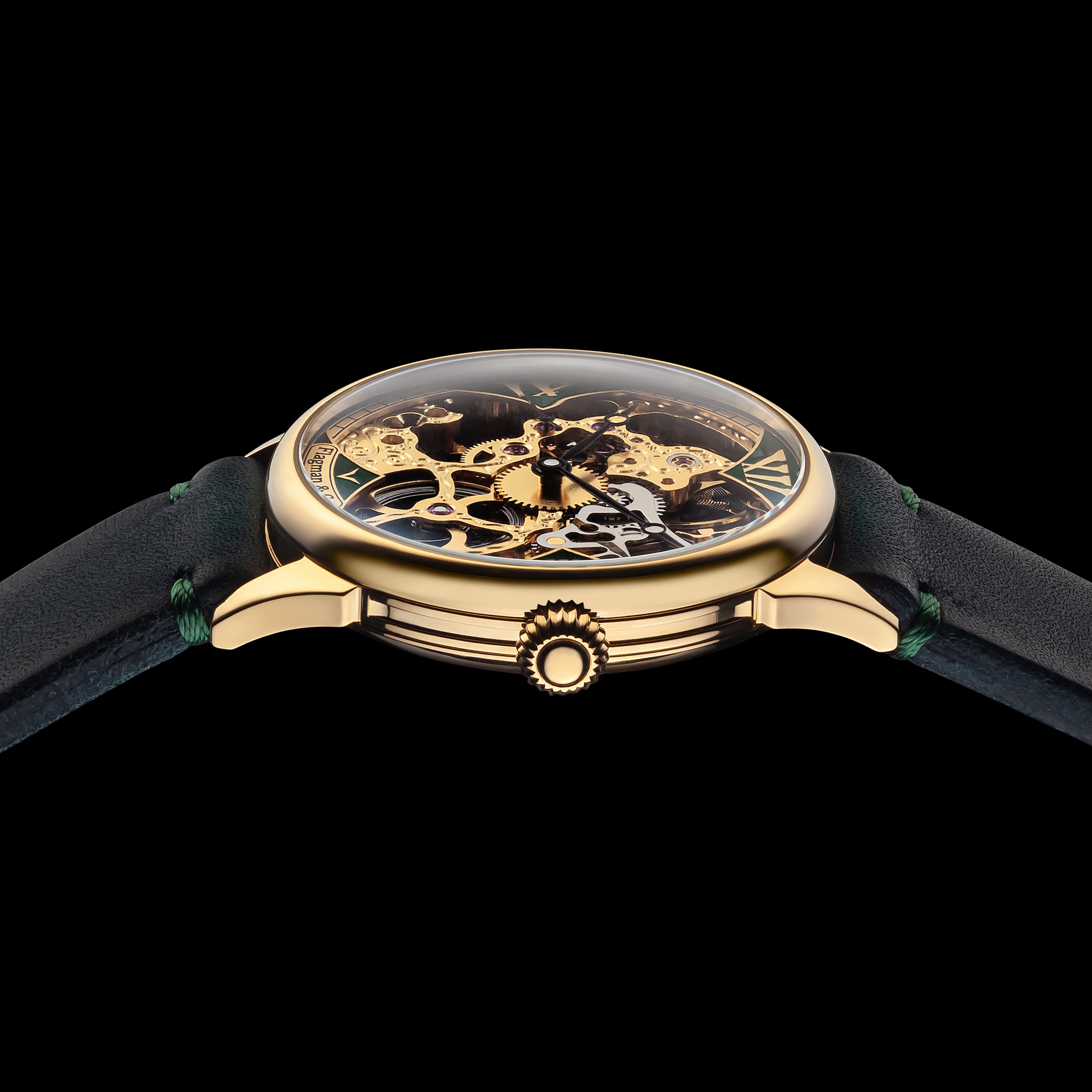 Luxury watch with gold case and green strap on a black background