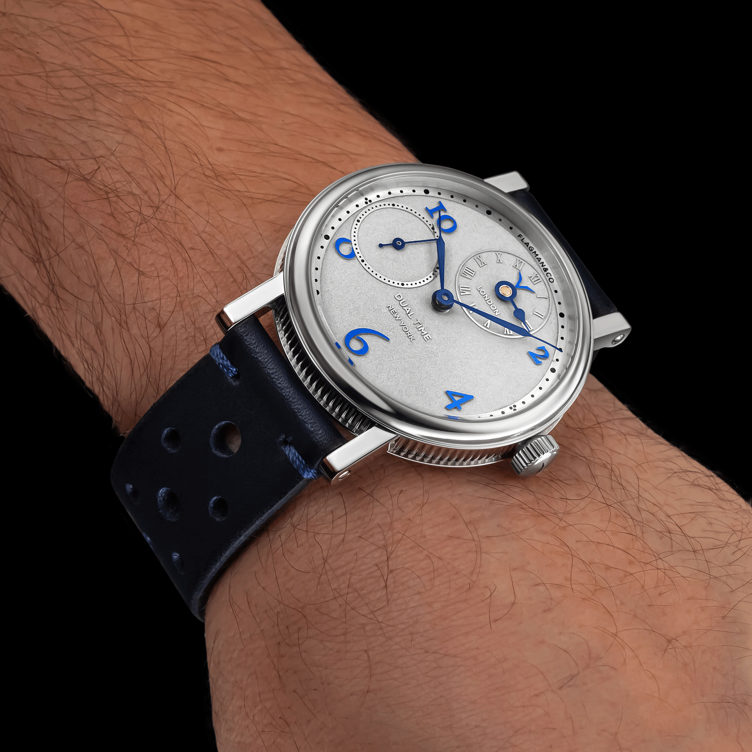 Handmade Watch with a blue strap on a wrist against a black background