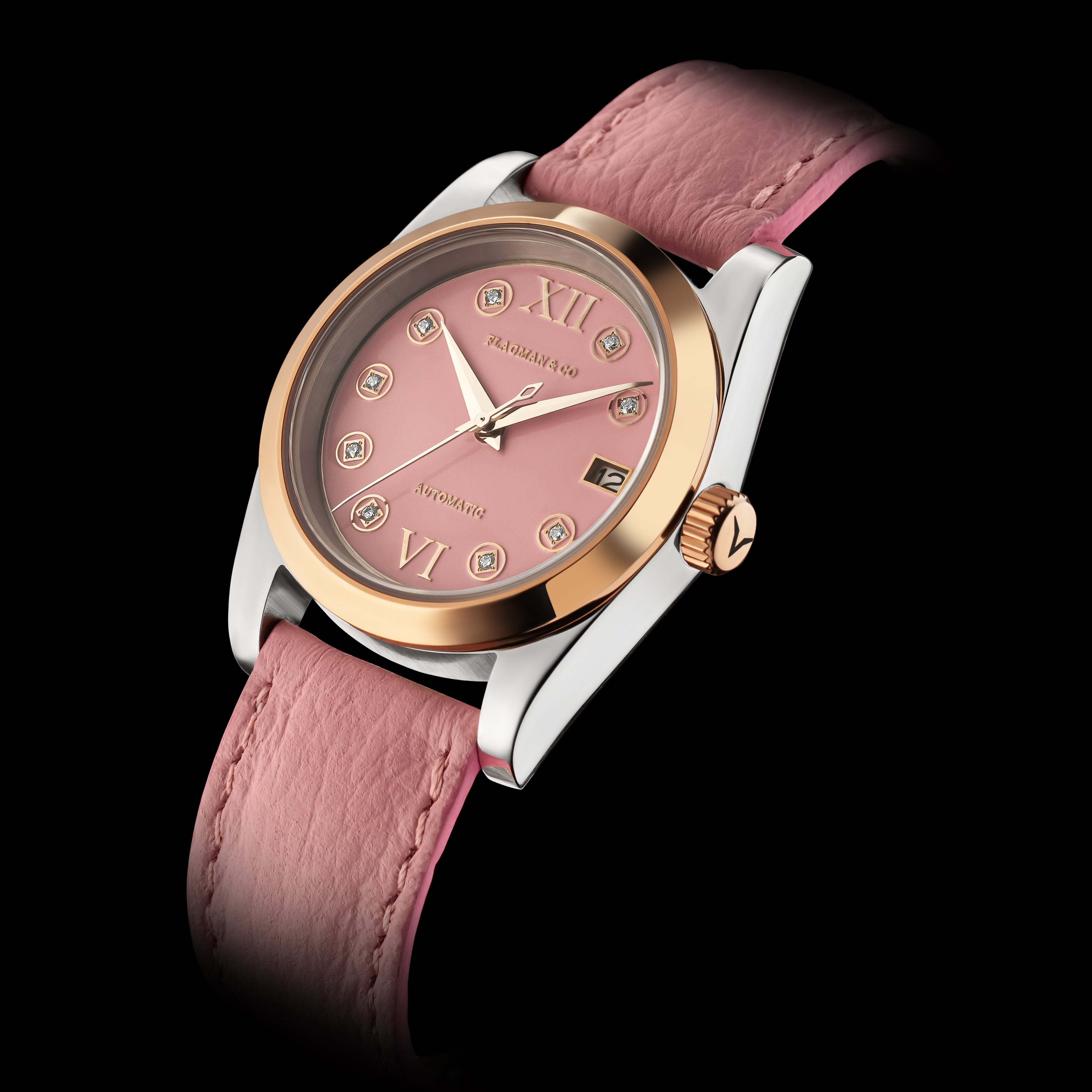 Watch with pink strap and rose gold case on black background