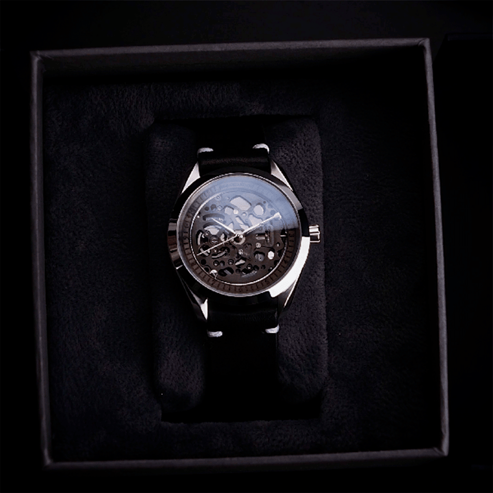 Steampunk watch with black strap in a dark box