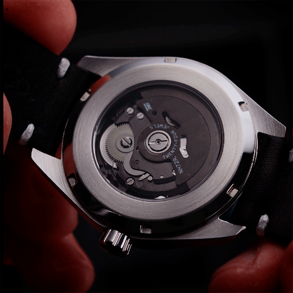 Close-up of a Steampunk watch with visible brand name on a dark background