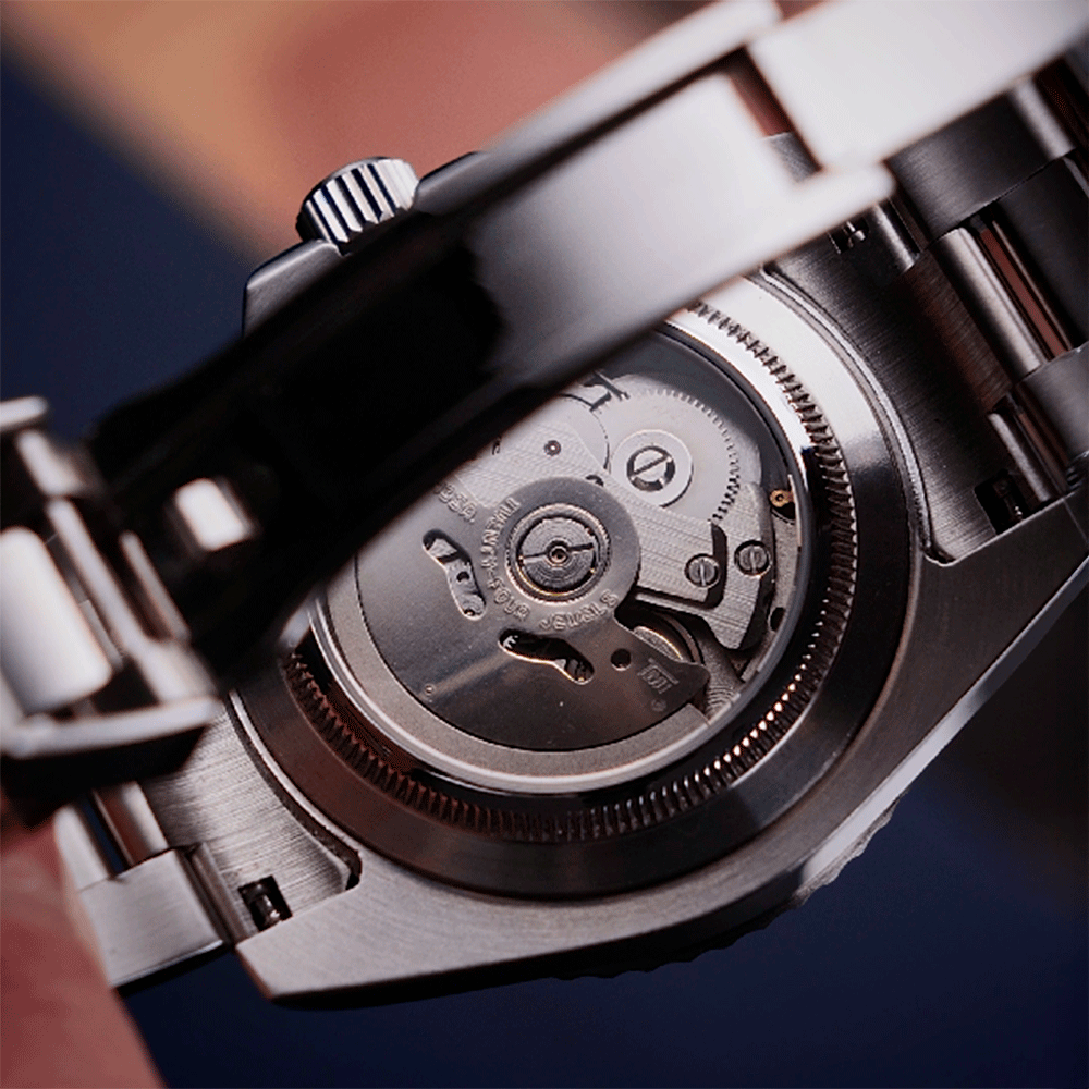 Close-up of a mechanical watch's inner workings with a blurred background