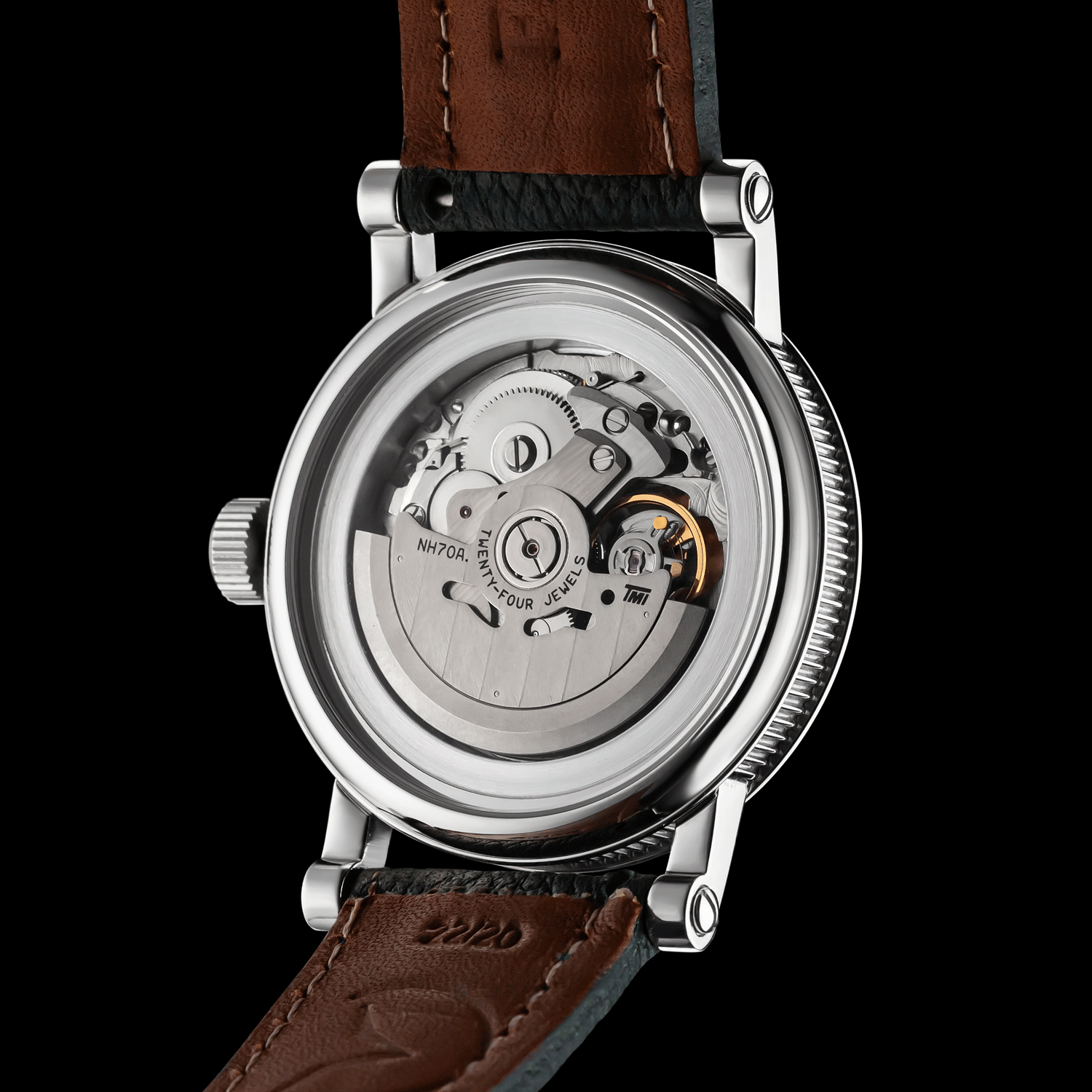 Watch with brown leather strap and visible mechanical components on a black background