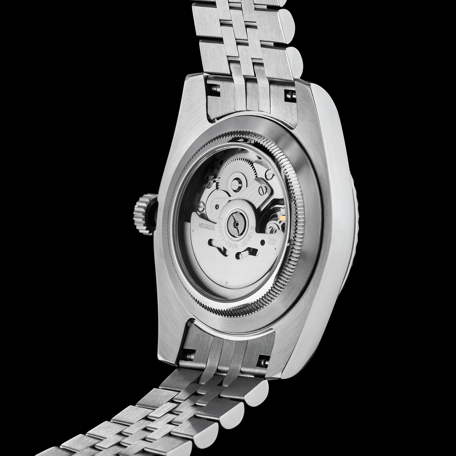Close-up of a silver watch with a visible mechanical movement on a black background