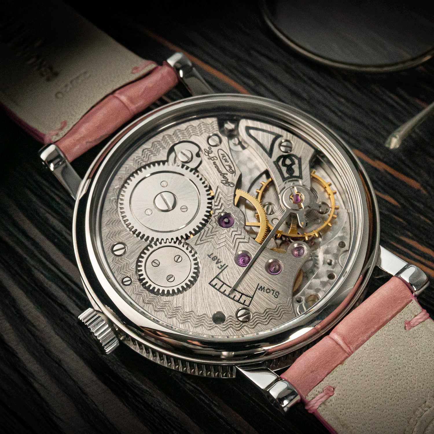 Art deco of a mechanical watch with pink leather strap on a dark background