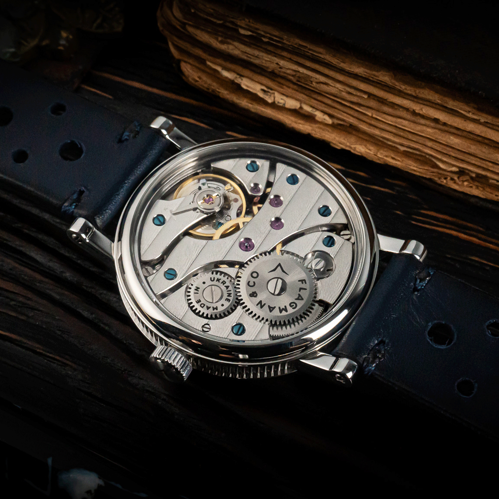 Rear view of Regulator Blue watch showing open caseback and manual winding movement