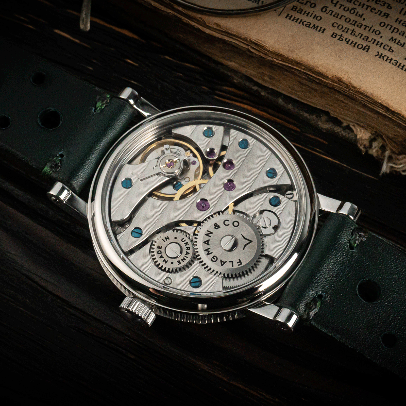 Rear view of Regulator Green watch showing open caseback and manual winding movement