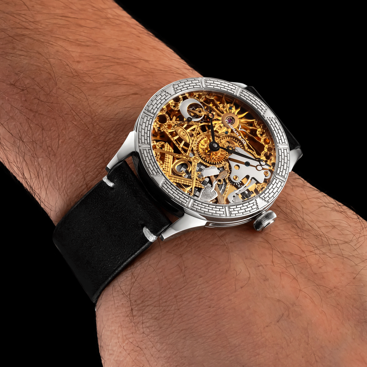 Luxury skeleton watch with black strap on a wrist against a dark background