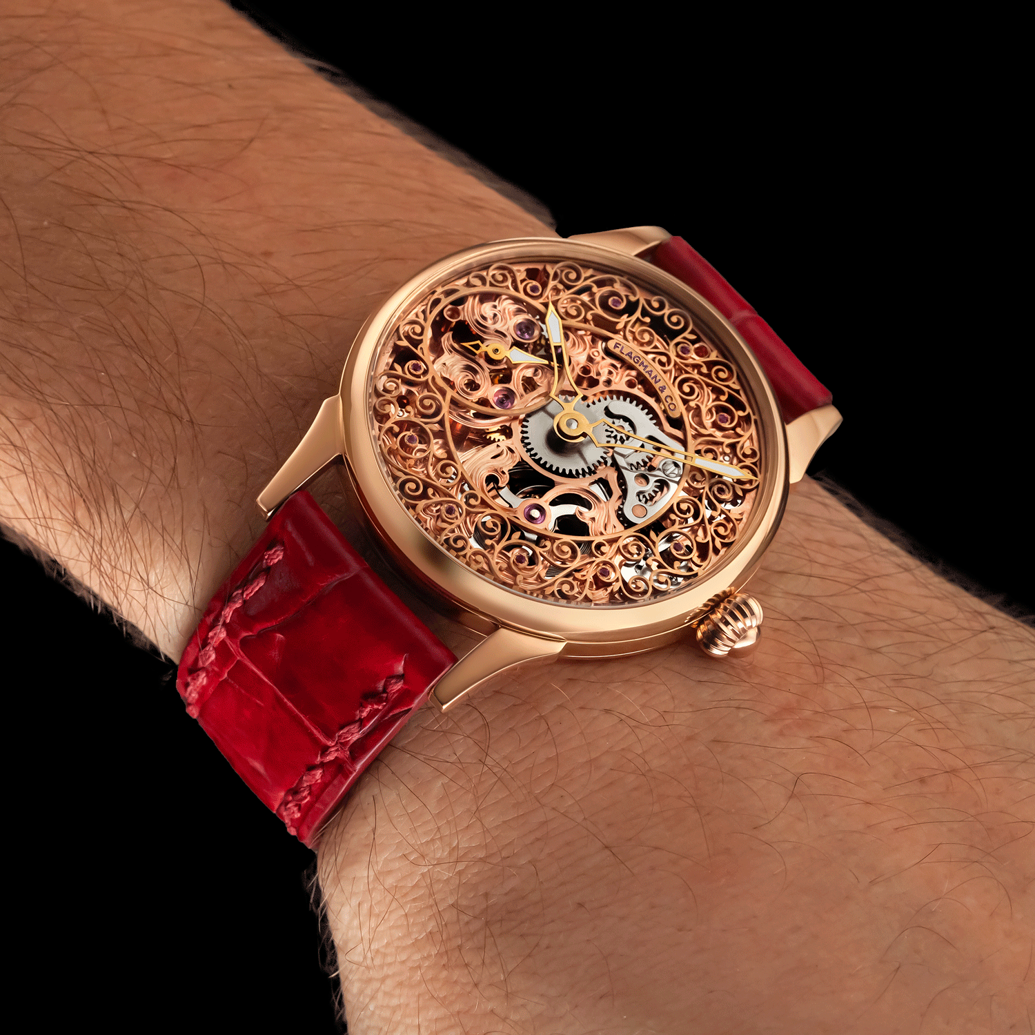 Unisex skeleton watch with red strap and intricate design on wrist against black background